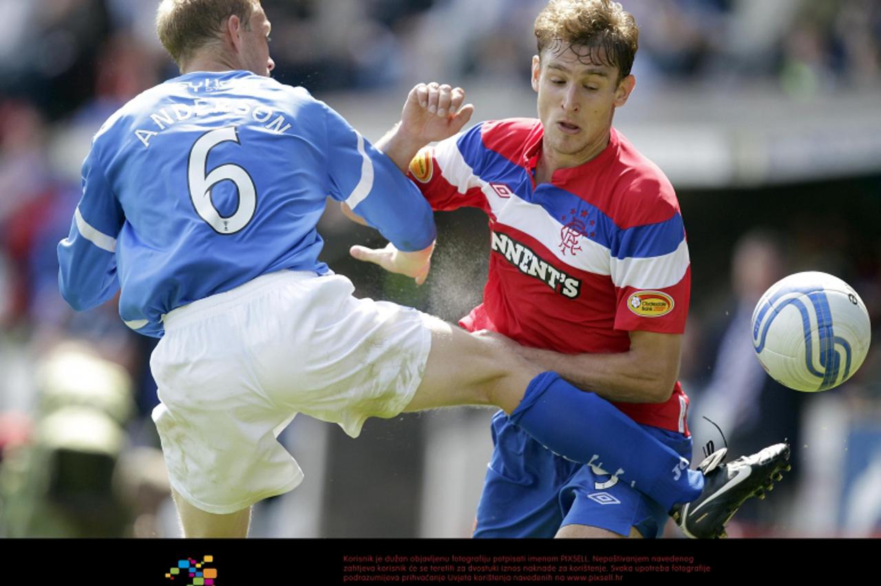 'St Johnstone\'s Steven Anderson (left) tussles with Rangers\' Nikica Jelavic during the Clydesdale Bank Scottish Premier League match at McDiarmid Park, Perth Photo: Press Association/Pixsell'