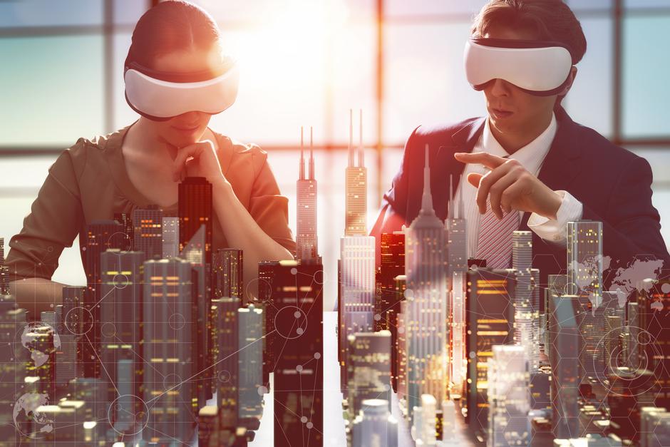 two business persons are developing a project using virtual reality goggles. the concept of technologies of the future