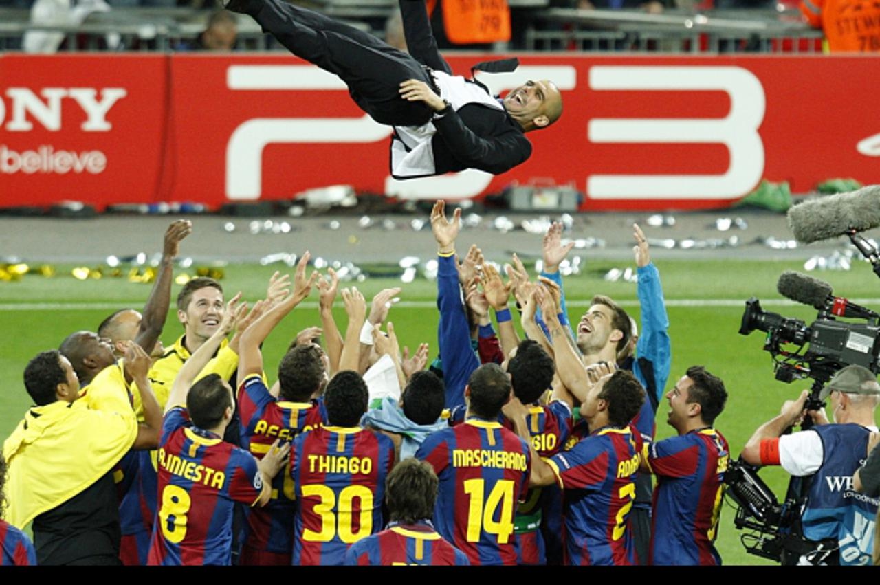 'Barcelona\'s players celebrate by throwing their manager Josep Guardiola up in the air Photo: Press Association/Pixsell'