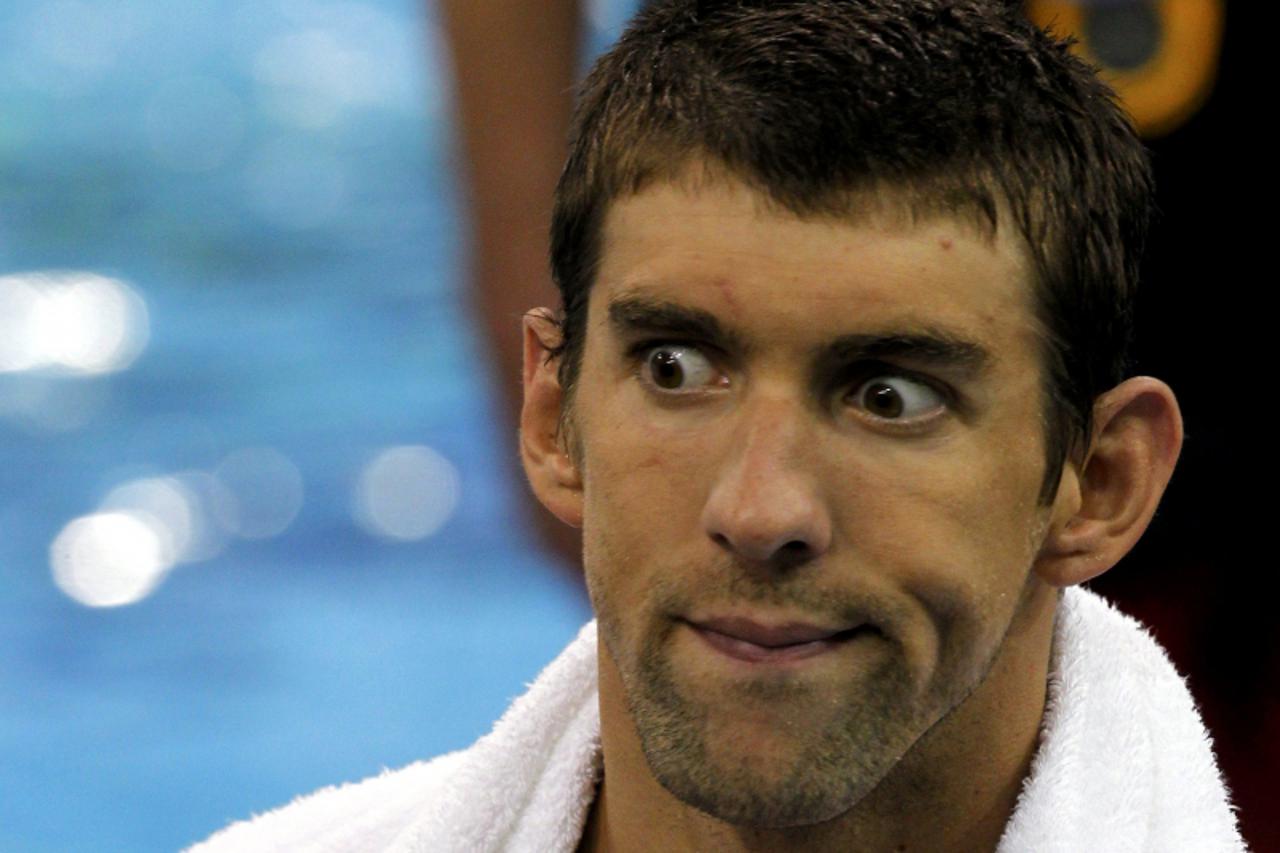 'U.S. swimming star Michael Phelps reacts during a training session at the 14th FINA World Championships in Shanghai July 22, 2011.     REUTERS/Christinne Muschi (CHINA  - Tags: SPORT SWIMMING HEADSHO