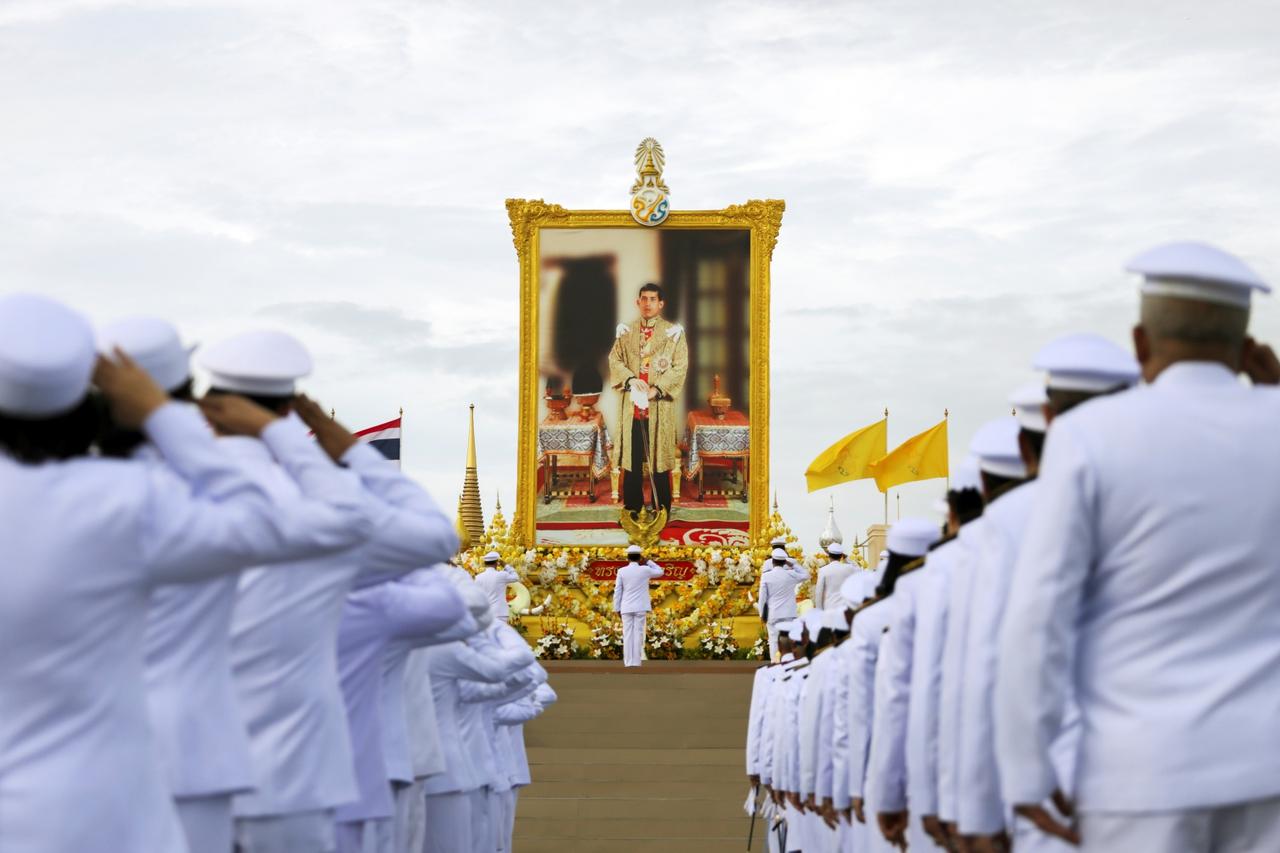 Thai officials pay respect next to a picture of Thailand's King Maha Vajiralongkorn outside the Grand Palace in Bangkok