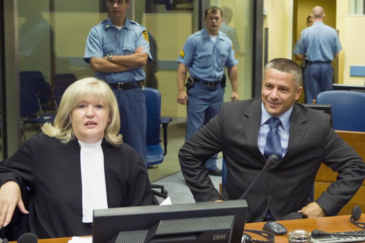 'Bosnian Muslim Naser Oric (R) and his lawyer Vasvija Vidovic sit in the courtroom of the International Criminal Tribunal for the former Yugoslavia (ICTY) as he waits for the judgement on his appeal i