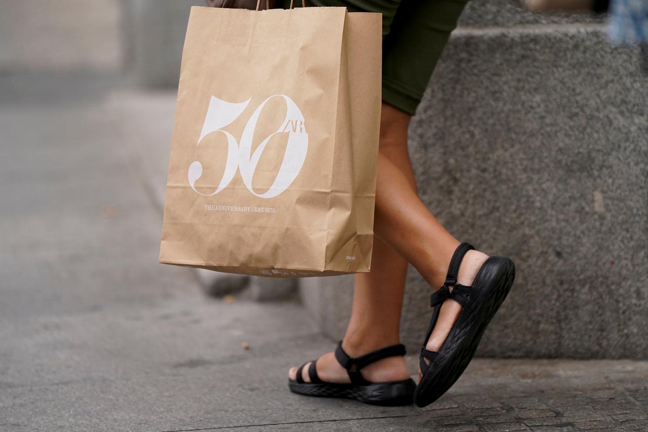 A person carries a Zara store bag at Plaza de Espana in Madrid