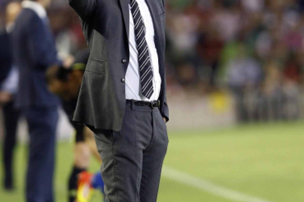 'Barcelona's coach Pep Guardiola gestures during their Spanish First Division soccer match against Real Betis at Benito Villamarin stadium in Seville May 12, 2012. REUTERS/Javier Diaz  (SPAIN - Tags:
