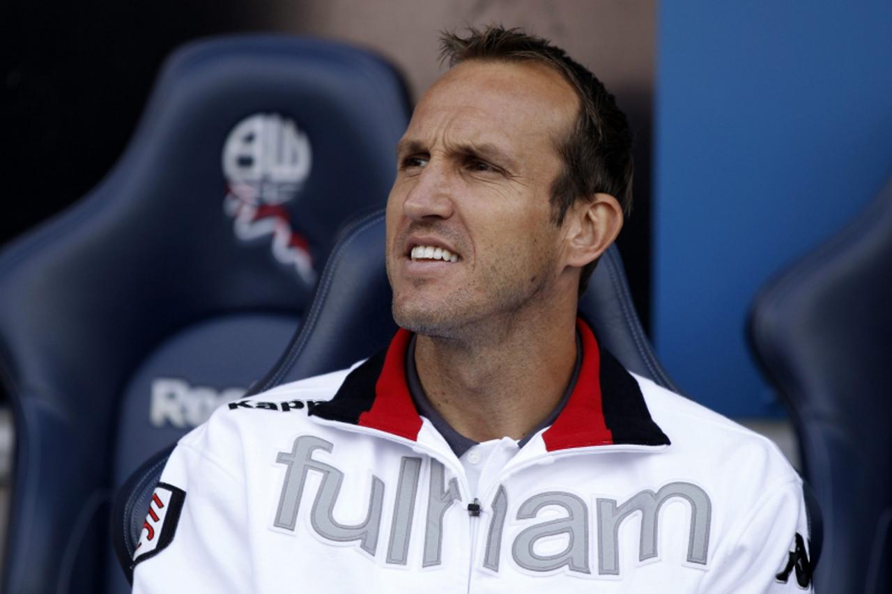 'Fulham\'s Mark Schwarzer takes his seat in the crowd before their English Premier League soccer match against Bolton Wanderers at the Reebok Stadium in Bolton, northern England, August 14, 2010. REUT
