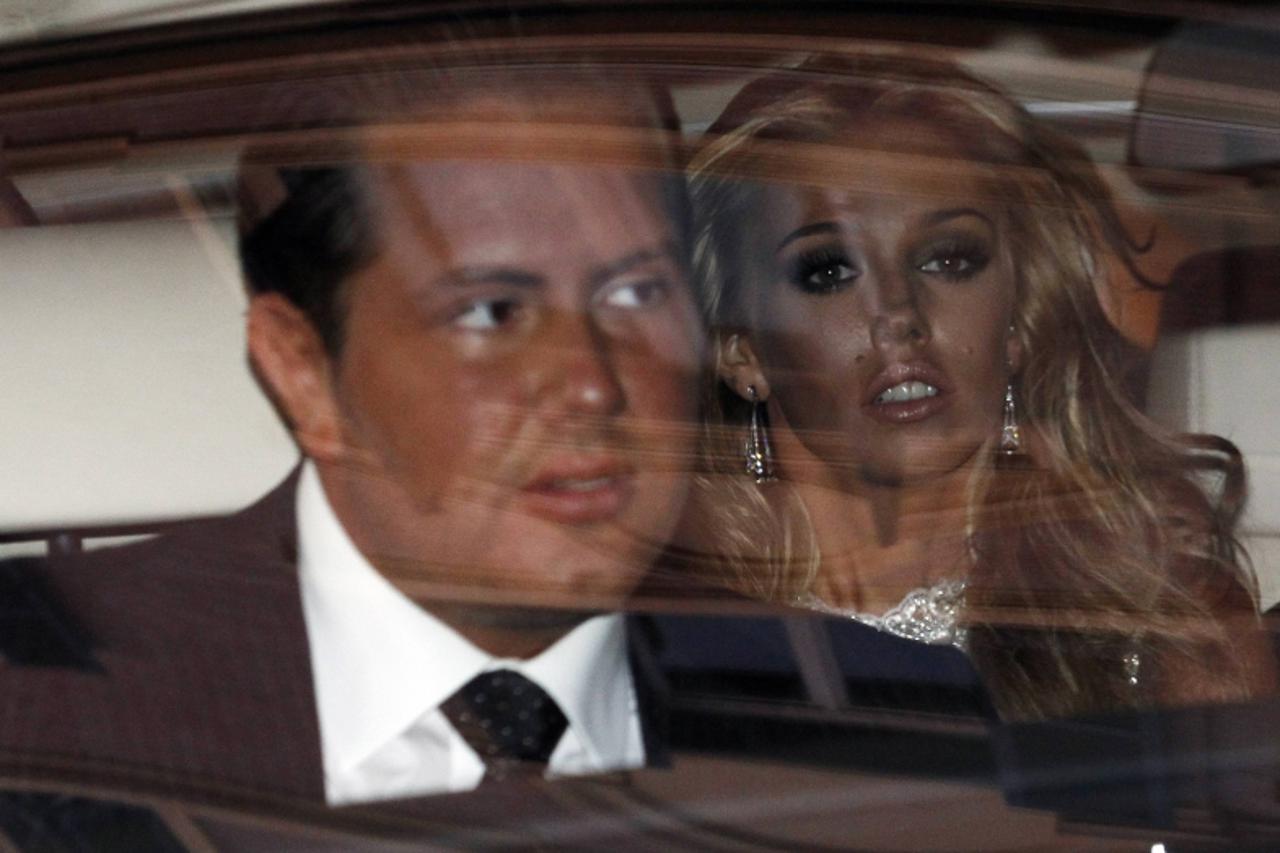 'Petra Ecclestone, daughter of Formula One Supremo Bernie Ecclestone, and her boyfriend James Stunt (L) leave a hotel in downtown Rome, August 26, 2011. Petra will marry her boyfriend of five years, J
