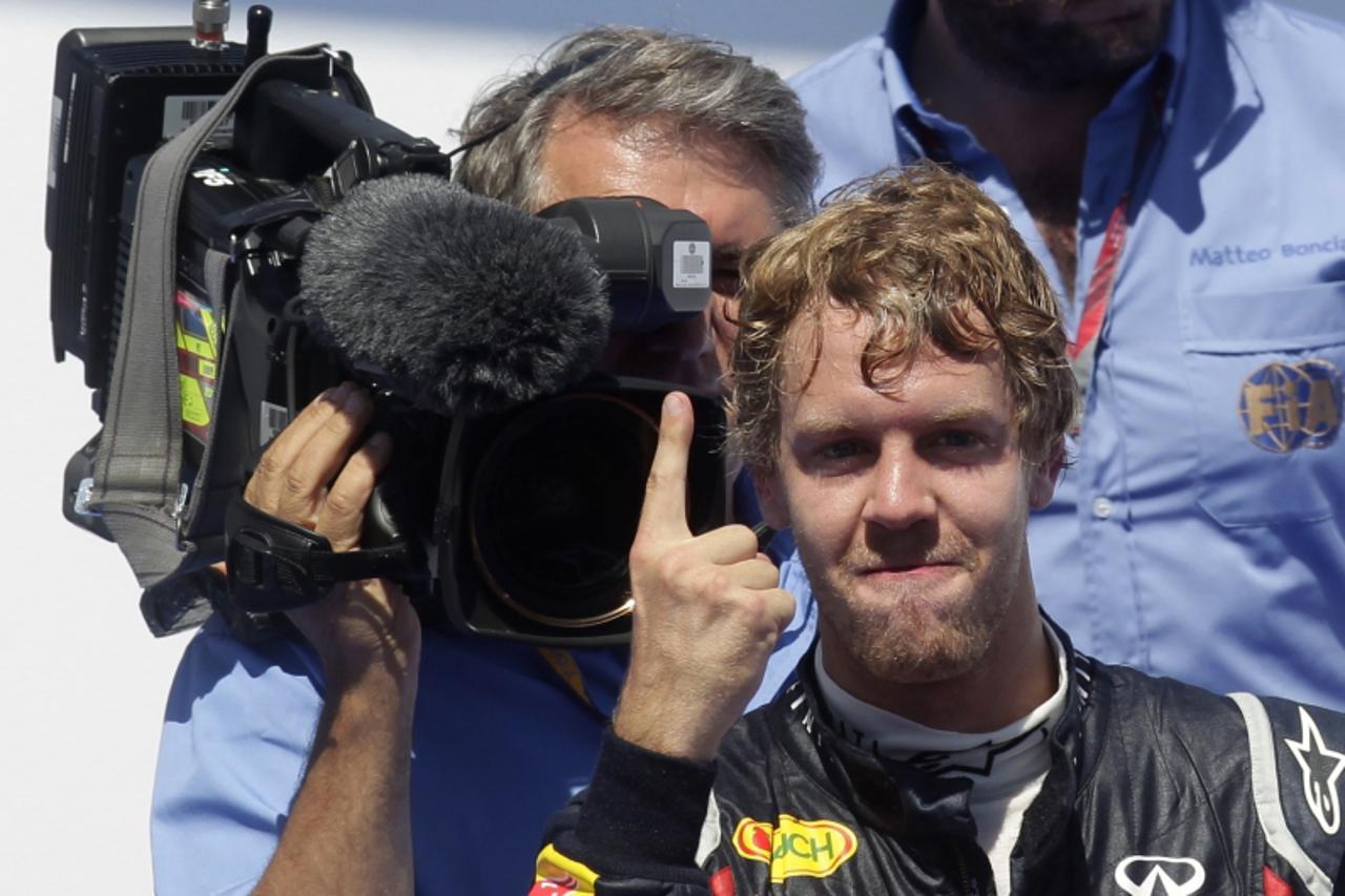 'Red Bull Formula One driver Sebastian Vettel of Germany celebrates after winning the European F1 Grand Prix in Valencia June 26, 2011.    REUTERS/Albert Gea (SPAIN - Tags: SPORT MOTOR RACING)'