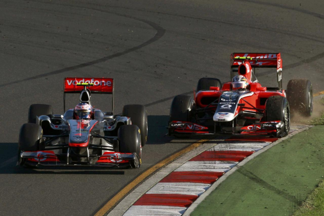 'McLaren Formula One driver Jenson Button of Britain and Virgin Formula One driver Jerome d'Ambrosio of Belgium drive during the Australian F1 Grand Prix at the Albert Park circuit in Melbourne Marc