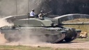 King Charles III Rides in Tank, Jokes It's 'Very Slow'