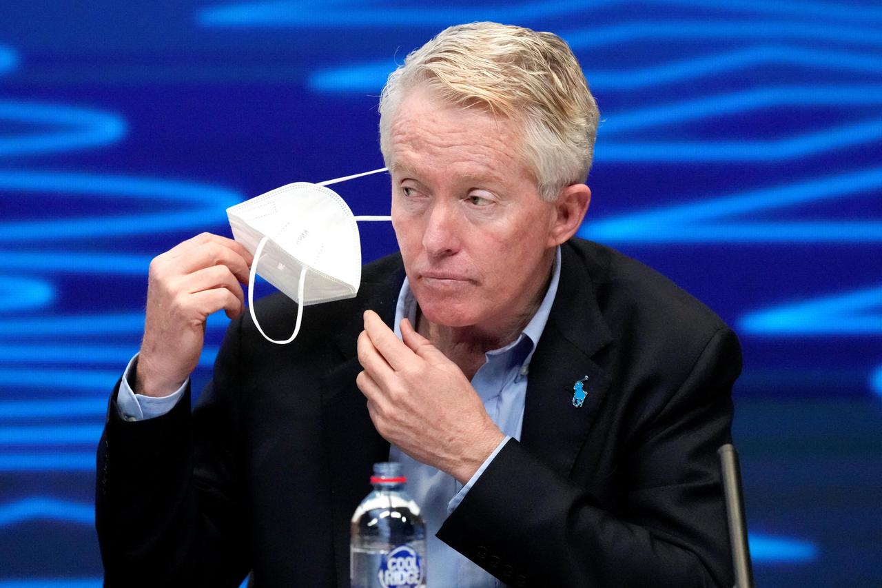 Australian Open tournament director Craig Tiley removes his mask during the draw for the Australian Open tennis championship in Melbourne