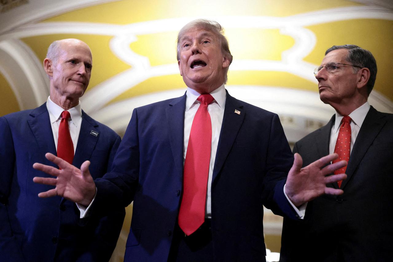 U.S. President Trump walks with Senate Majority Leader John Thune (R-SD) to the Senate Republican Steering Committee lunch, in Washington