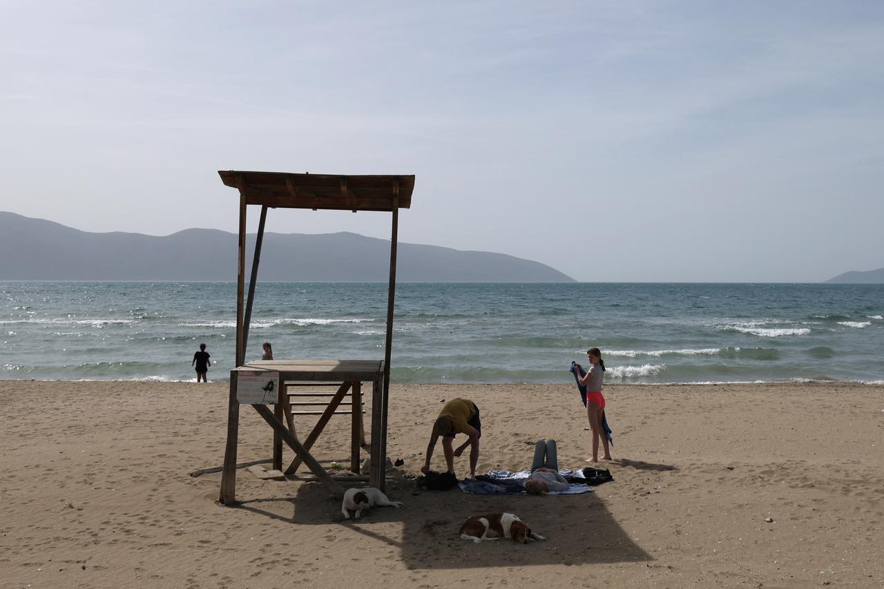 Tourists enjoy the sun on the beach in Vlora