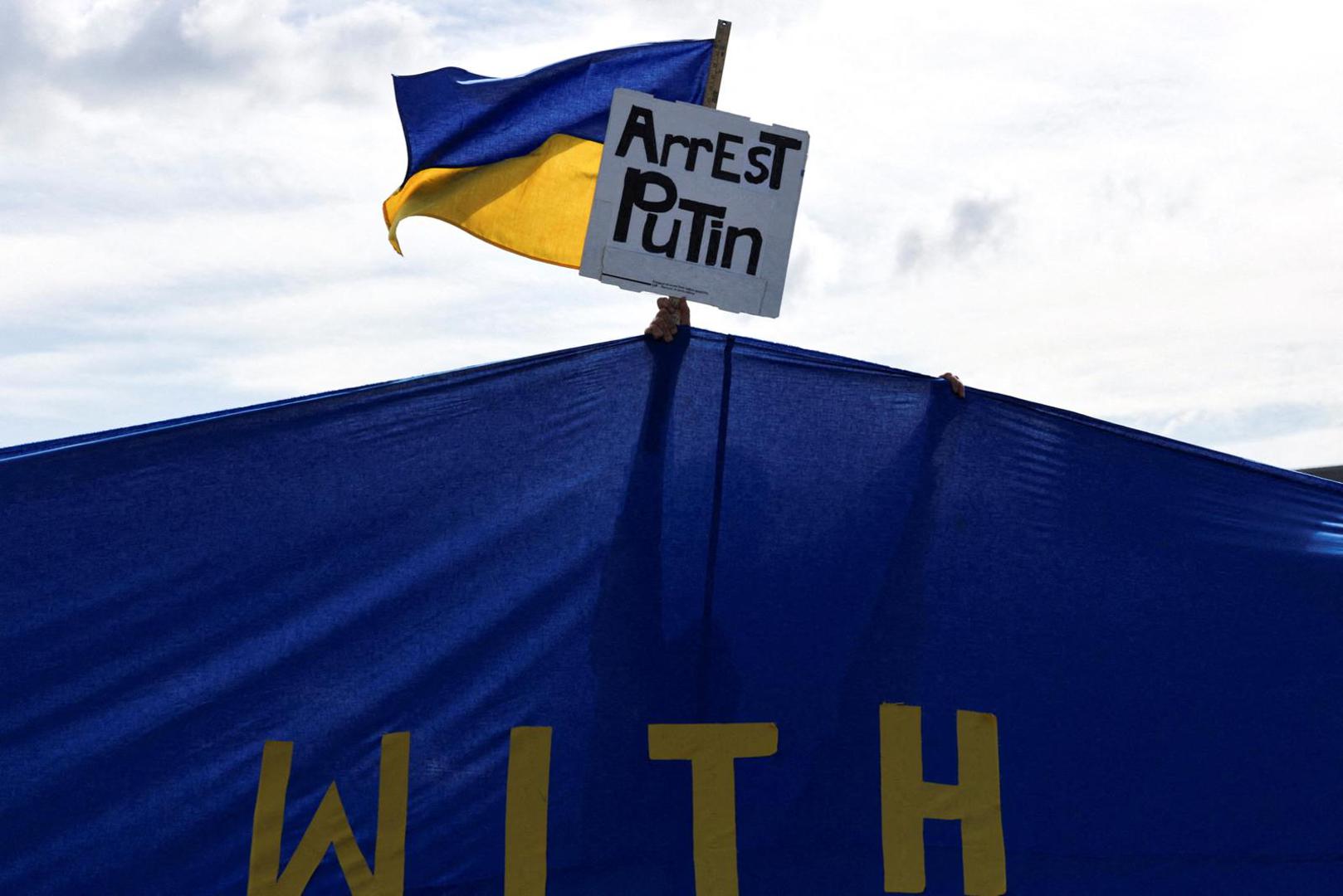 A pro-Ukraine supporter holds a placard and a Ukrainian flag during the "Alaska Stands with Ukraine" rally near Seward Highway in Anchorage, Alaska, U.S., August 14, 2025. REUTERS/Jeenah Moon  REFILE - QUALITY REPEAT     TPX IMAGES OF THE DAY Photo: JEENAH MOON/REUTERS