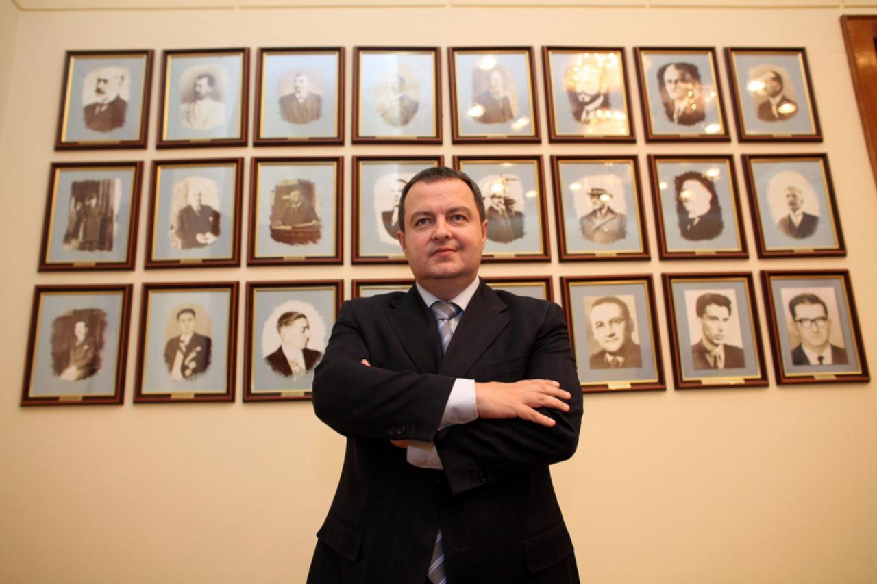 'Serbian Socialist leader Ivica Dacic poses in front of photos of former Serbian interior ministers at his office in Belgrade in this January 26, 2011 file photo. Dacic received a mandate on June 28, 