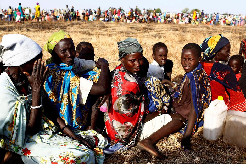 FILE PHOTO: Women and children wait to be registered prior to a food distribution carried out by the United Nations World Food Programme (WFP) in Thonyor, Leer state, South Sudan