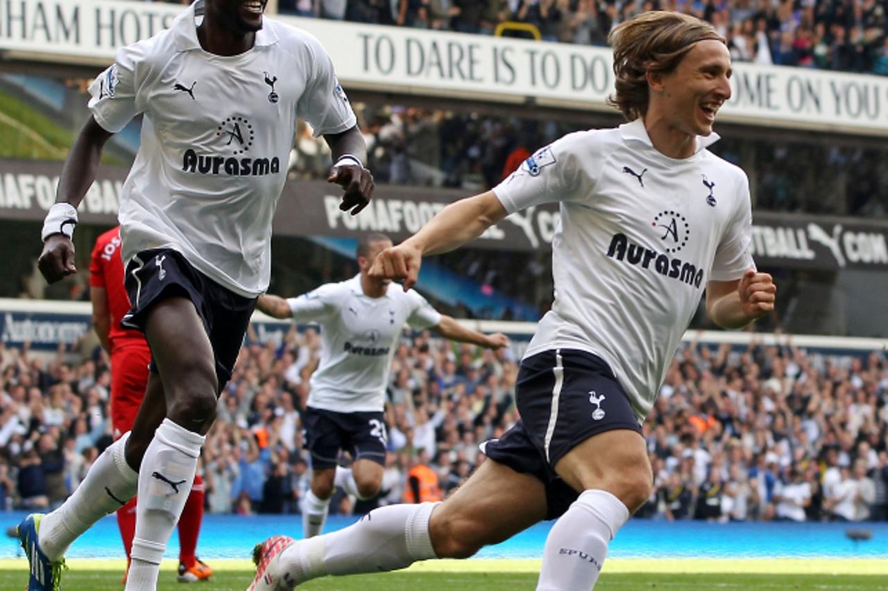 \'Tottenham Hotspur\'s Croatian midfielder Luka Modric (R) celebrates scoring the opening goal with team-mate, Togolese striker Emmanuel Adebayor (L) during of the English Premier League football matc