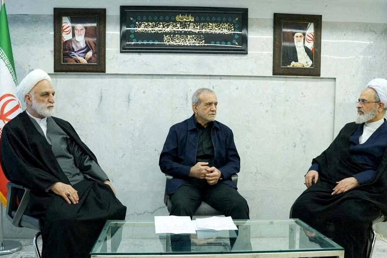 FILE PHOTO: Iranian President Pezeshkian, Mohseni-Eje'i, and Arafi attend the meeting of the interim leadership council of Iran in an unknown location in Iran