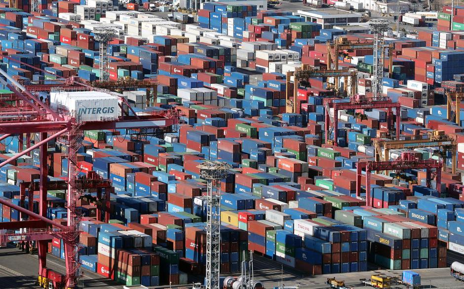 Cargo containers are piled up at a yard on the ninth day of a nationwide strike by truckers, in a port in Busan