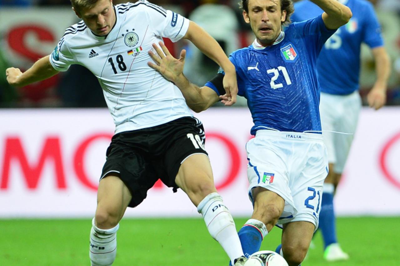 'Italian midfielder Andrea Pirlo (R) vies with German midfielder Toni Kroos during the Euro 2012 football championships semi-final match Germany vs Italy on June 28, 2012 at the National Stadium in Wa