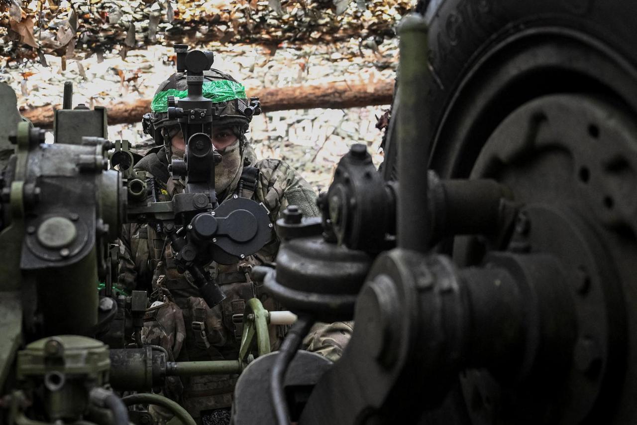 Ukrainian serviceman prepares to fire a howitzer towards Russian troops at a position in a front line near the town of Pokrovsk