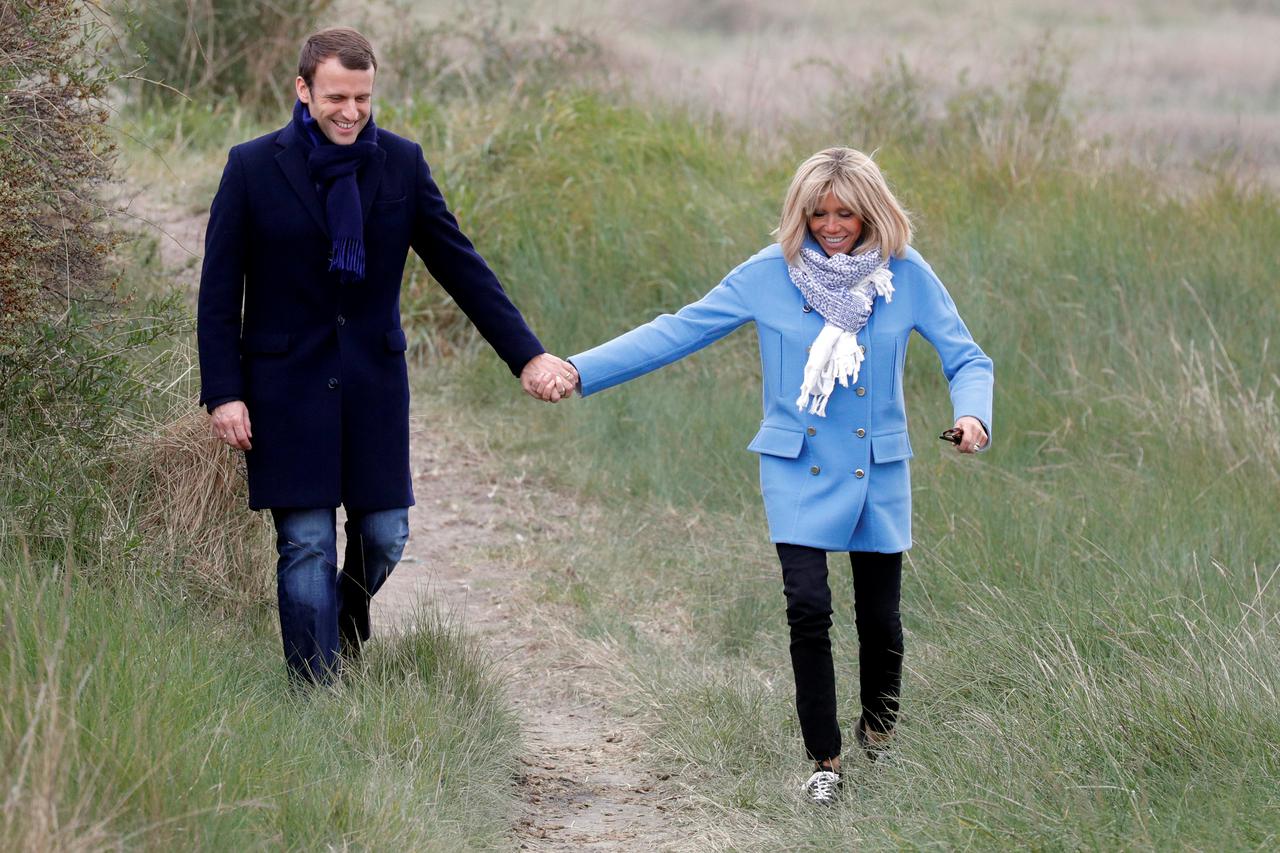 Emmanuel Macron, head of the political movement En Marche!, or Onwards!, and candidate for the 2017 French presidential election and his wife Brigitte Trogneux pose in countryside in Le Touquet, France, on the eve of France's first round of the Presidenti