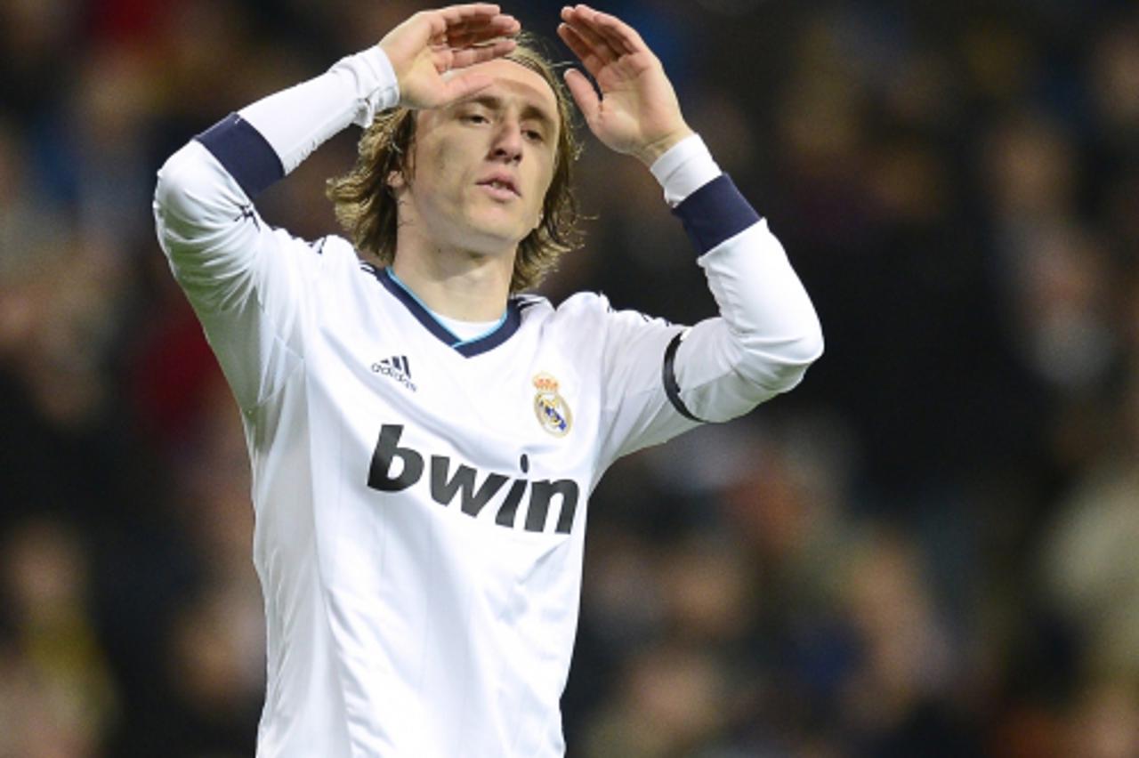 'Real Madrid\'s Croatian midfielder Luka Modric reacts during the Spanish league football match Real Madrid CF vs RCD Espanyol at the Santiago Bernabeu stadium in Madrid on December 16, 2012.   AFP PH