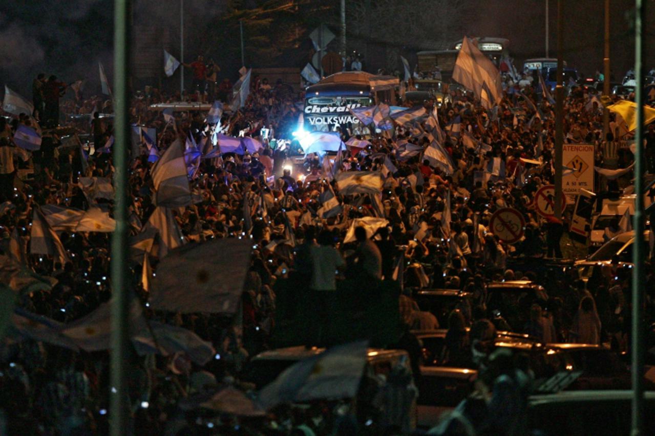 'Argentine national soccer team supporters surround the bus wich brings the players upon their arrival at Ezeiza airport in Buenos Aires, on July 4, 2010. Diego Maradona and his Argentina team receive