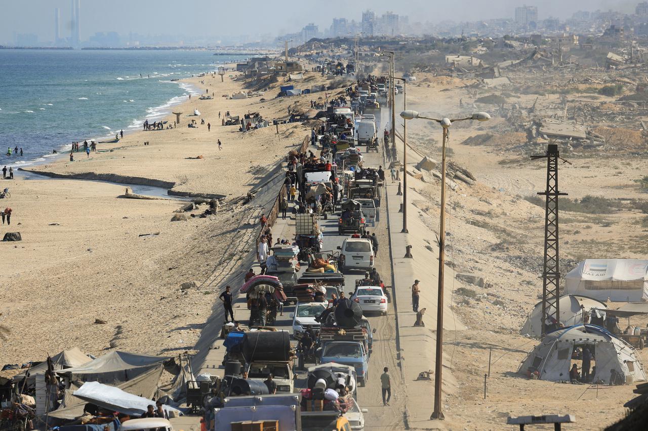 Displaced Palestinians, fleeing northern Gaza due to an Israeli military operation, move southward, in the central Gaza Strip