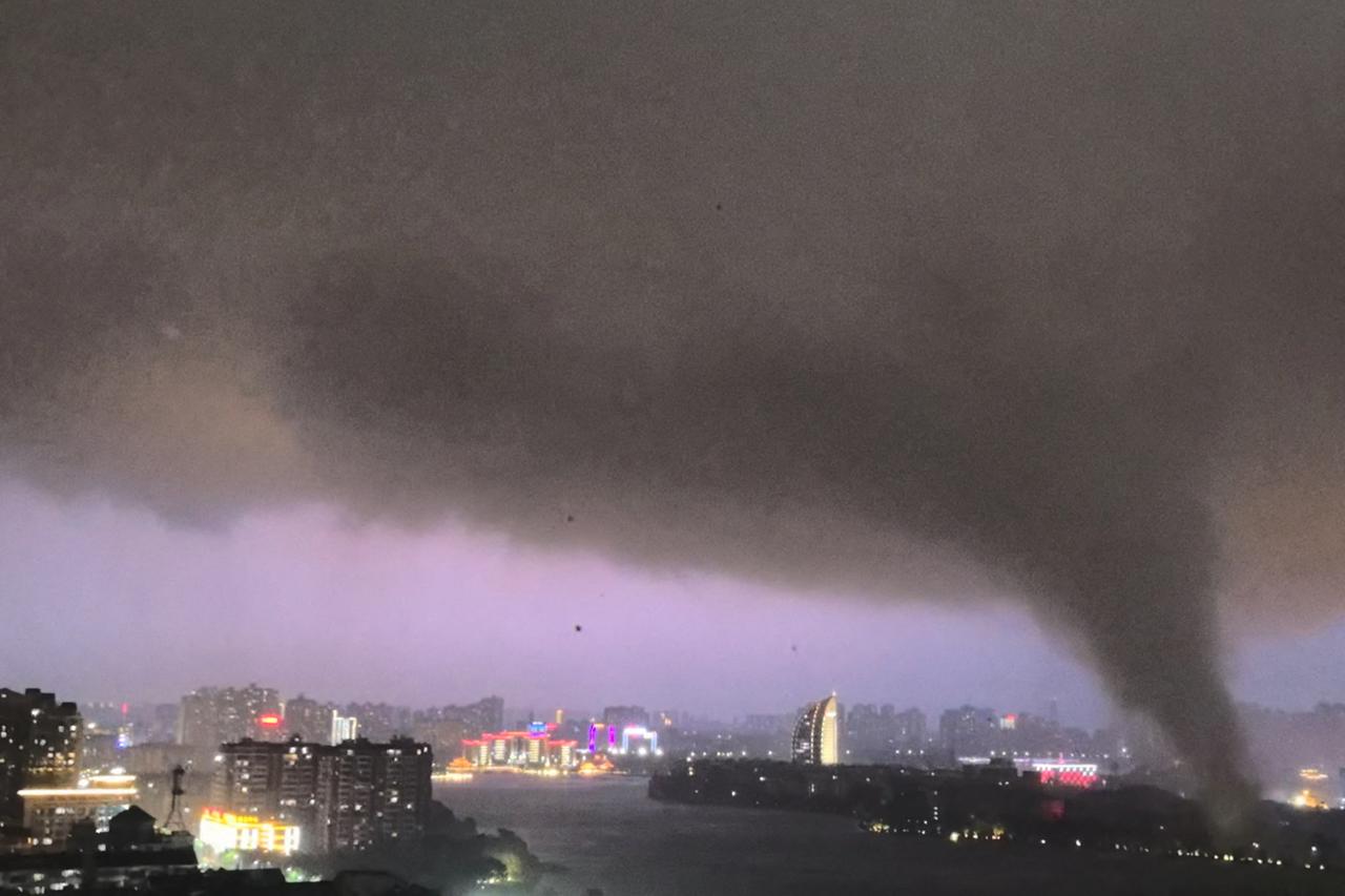 A tornado moves through an area amid lightning and strong winds, in Ezhou
