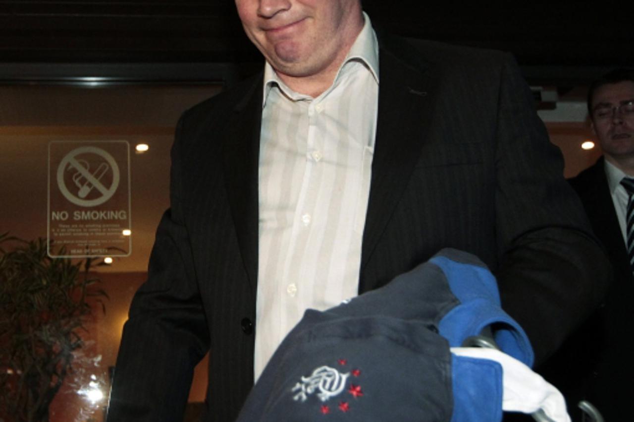 'Rangers manager Ally McCoist leaves their Ibrox Stadium in Glasgow, Scotland February 14, 2012. Scottish soccer champions Rangers went into administration on Tuesday after running into financial prob