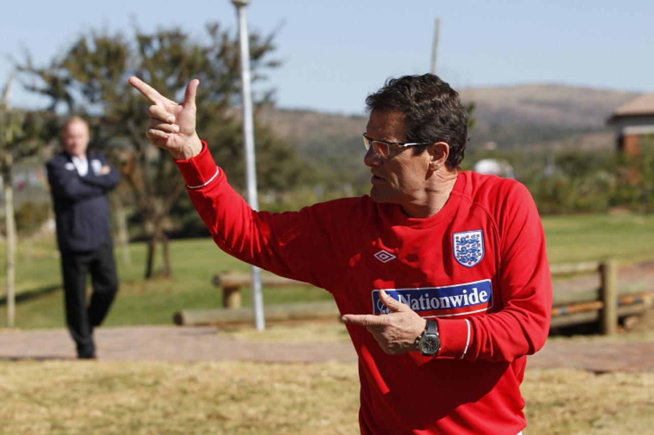 'England\'s coach Fabio Capello gestures to members of the media during a training session at the Royal Bafokeng Sports Campus near Rustenburg, June 9, 2010.   REUTERS/Darren Staples   (SOUTH AFRICA -