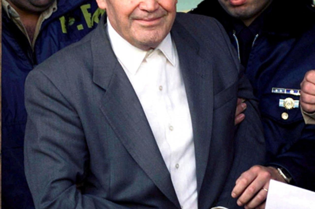 'Former World War Two concentration camp commander Dinko Sakic leaves a federal Argentine courthouse under heavy guard in this file photo May 1, 1998, shortly after being arrested. He was extradited t