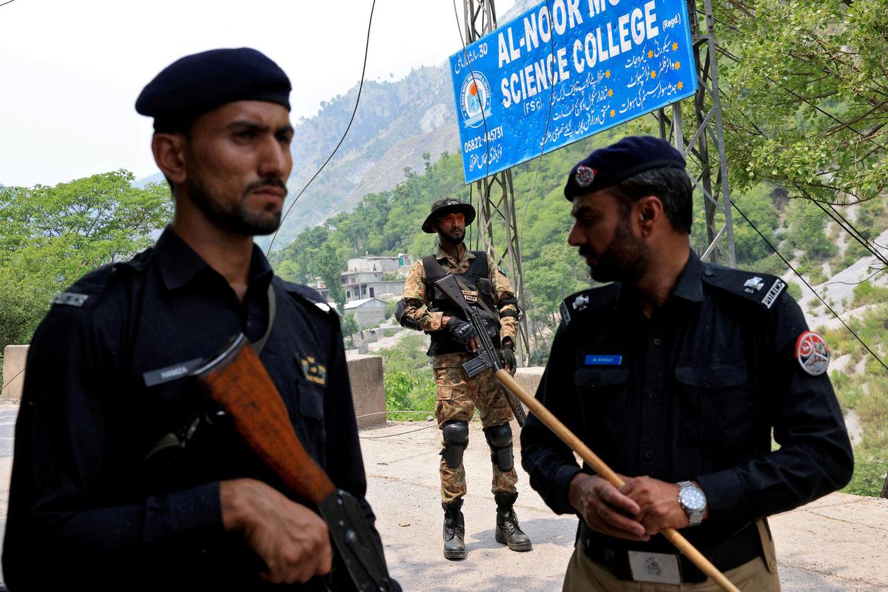 Security force personnel  stand guard on a road leading to Bilal Mosque after it was hit by an Indian strike in Muzaffarabad