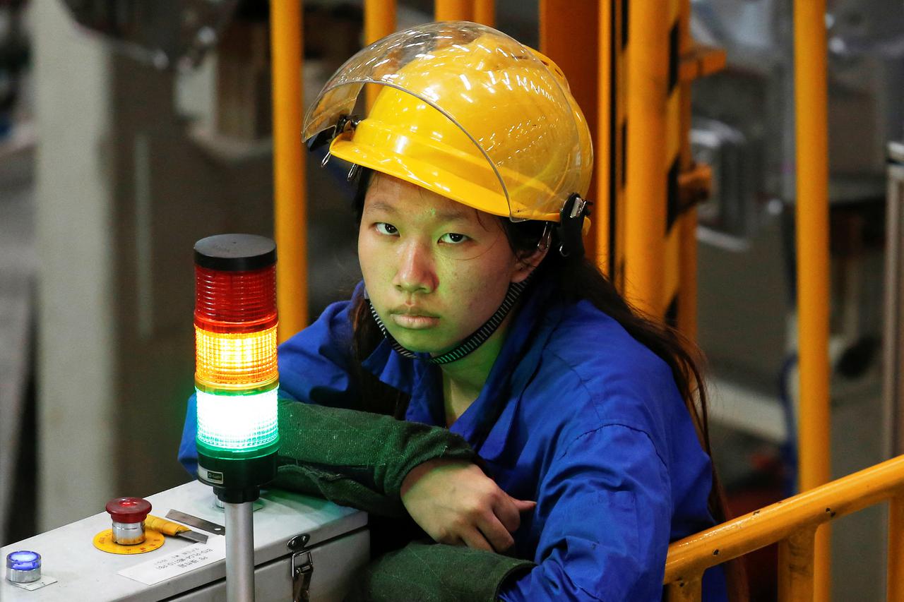FILE PHOTO: A worker looks on at a BYD weld line in Shenzhen