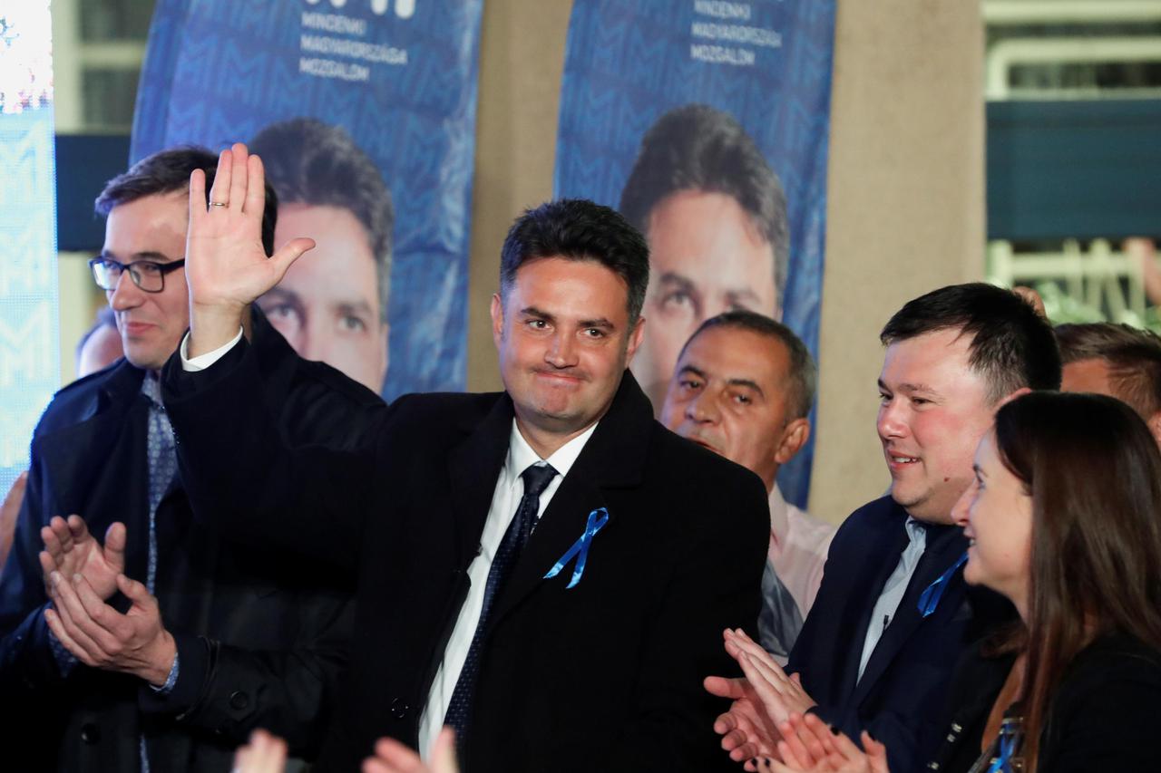 Opposition candidate for prime minister Peter Marki-Zay, next to Budapest's Mayor Gergely Karacsony, waves at the election headquarters in Budapest