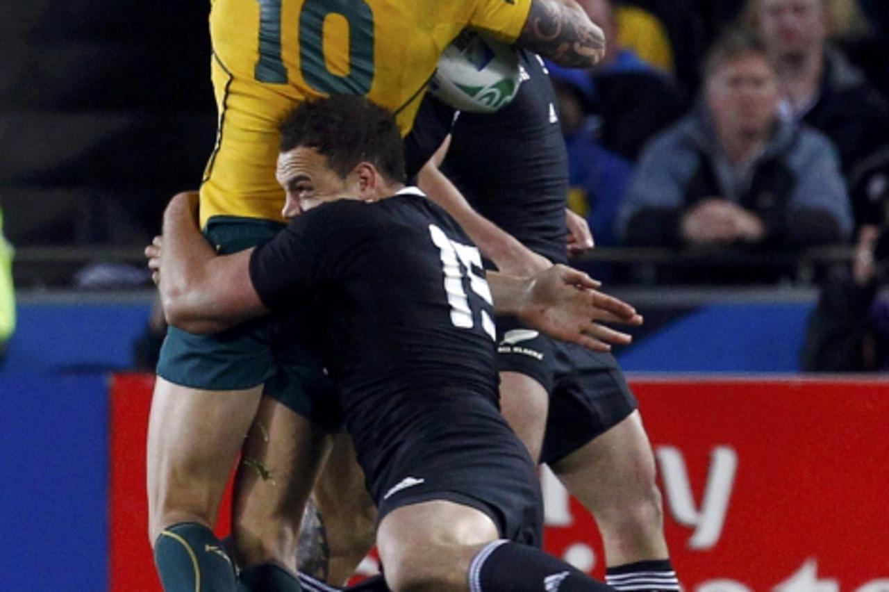 'New Zealand All Blacks\' Sonny Bill Williams (rear) makes an illegal tackle on Australia Wallabies\' Quade Cooper (L) during their Rugby World Cup semi-final match at Eden Park in Auckland October 16