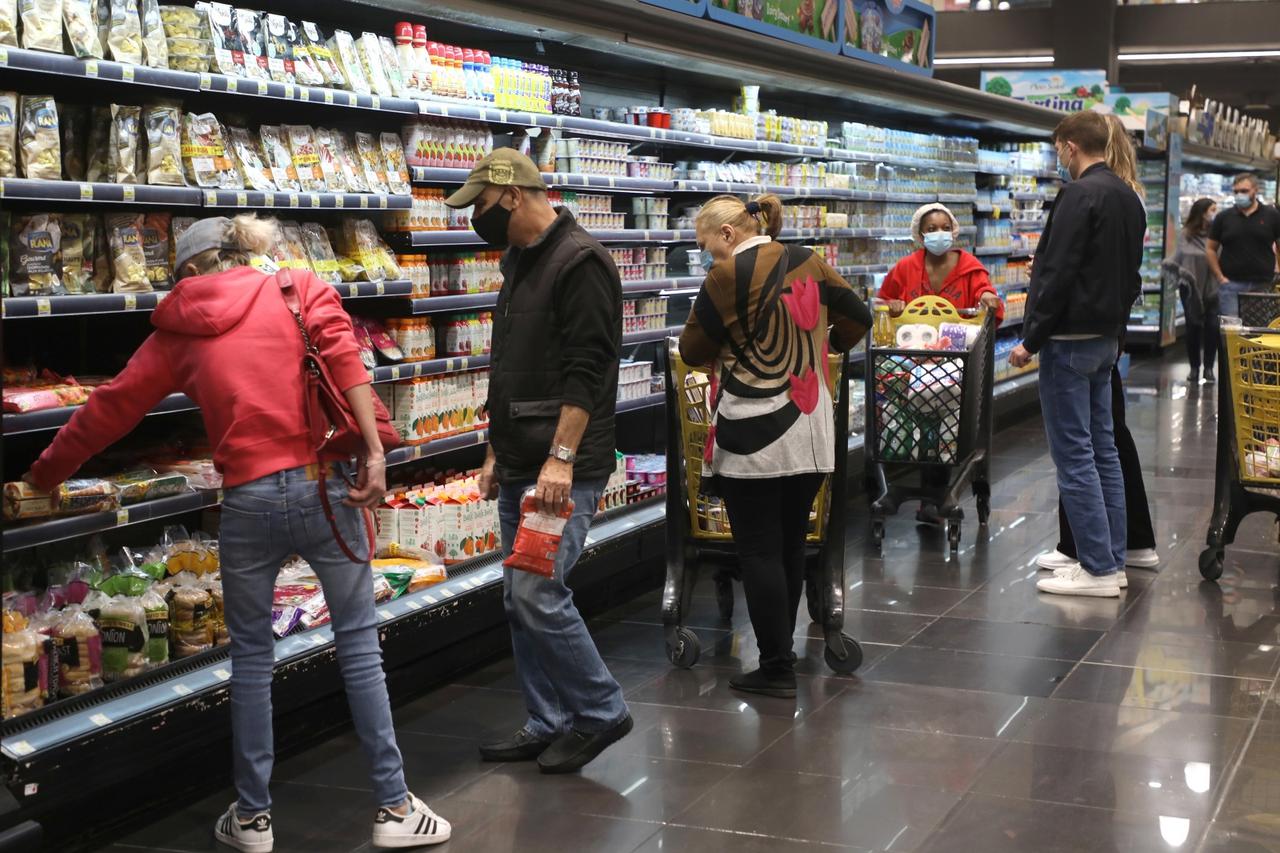 People shop at a supermarket ahead of a tightened lockdown and a 24-hour curfew to curb the spread the coronavirus disease (COVID-19) outbreak in Beirut