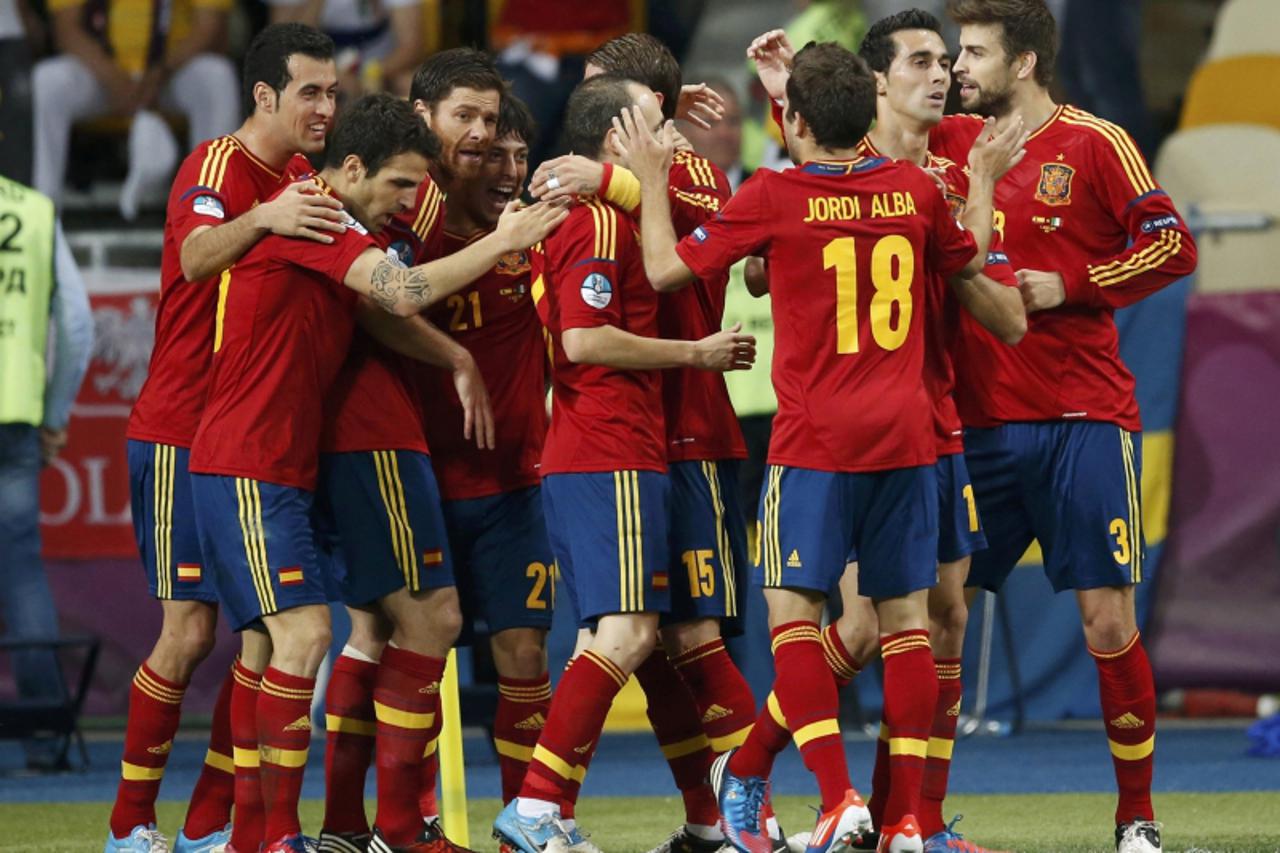 'Spain\'s David Silva is congratulated by his team mates after scoring a goal against Italy during their Euro 2012 final soccer match at the Olympic stadium in Kiev July 1, 2012.               REUTERS