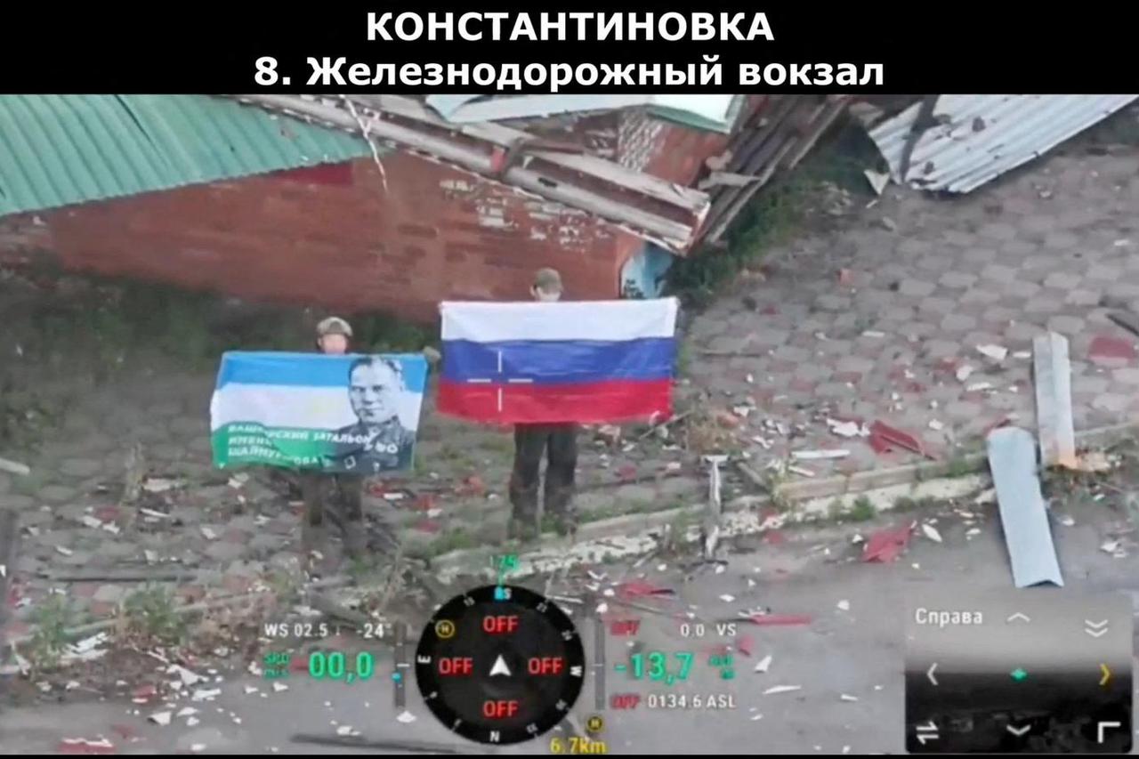 A drone view shows soldiers, with one holding up a Russian flag, as the Russian defence ministry says its forces had taken control of Kostiantynivka