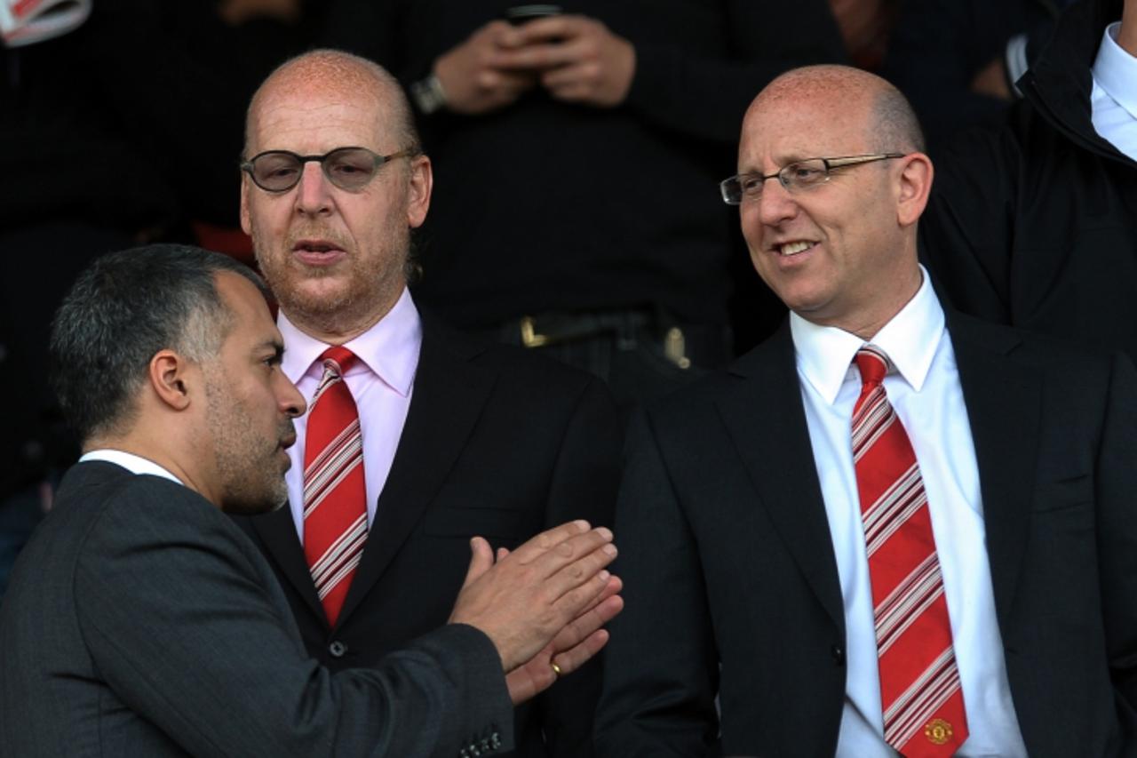 'Manchester United Directors Avram (C) and Joel (R) Glazer wait for their team to take on Tottenham Hotspur before their English Premier League football match at Old Trafford in Manchester, north-west