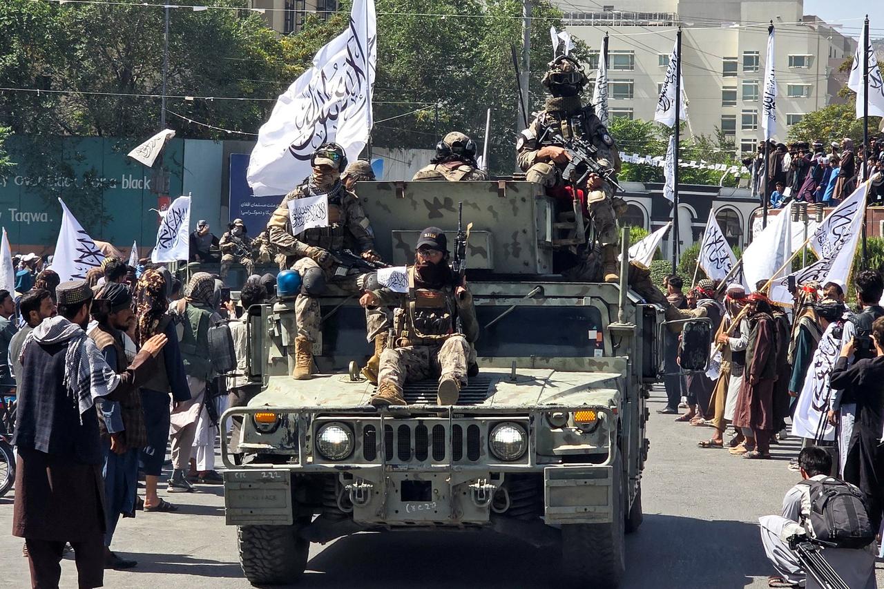Members of the Taliban attend a rally to mark five years in power, in Kabul