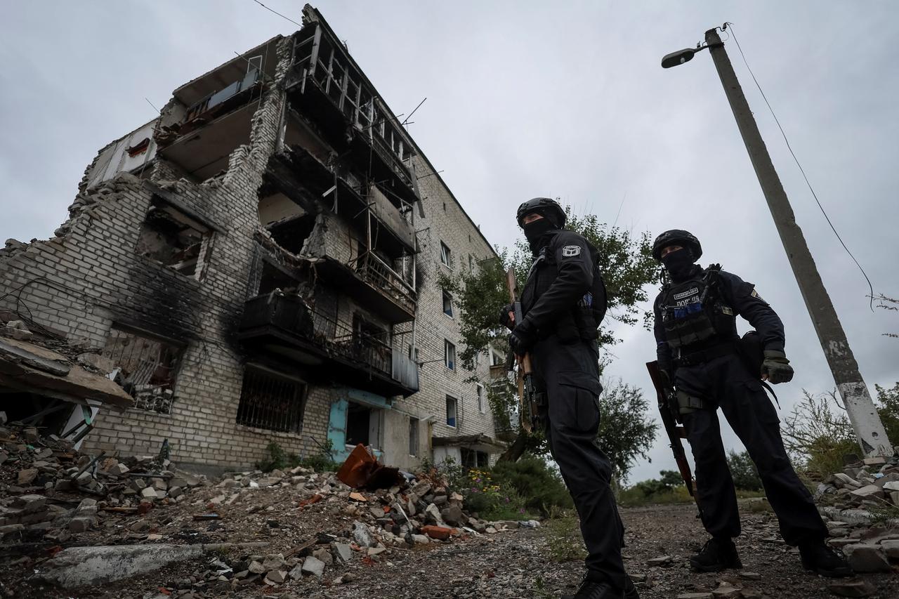 Ukrainian police patrol an area, as Russia's attack on Ukraine continues, in the town of Izium