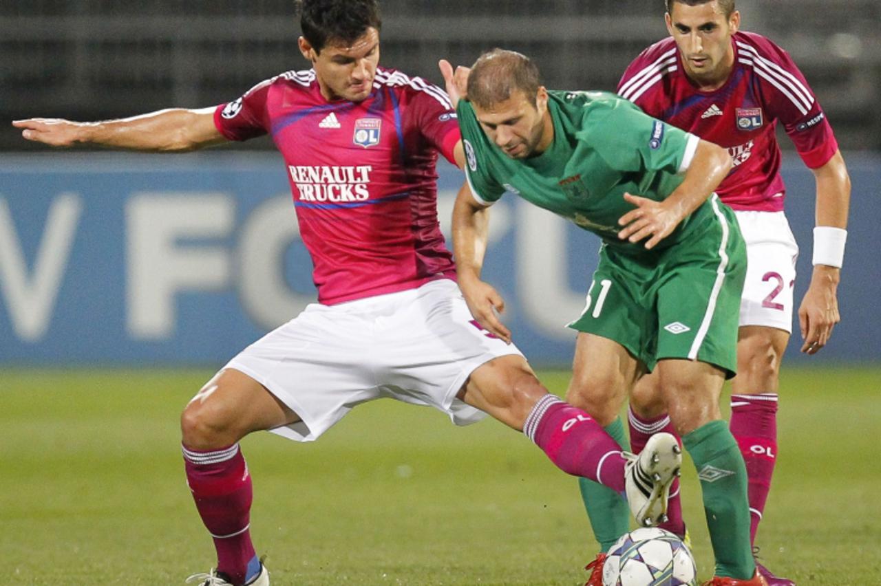 \'Olympique Lyon\'s Dejan Lovren (L) challenges Gokdeniz Karadeniz (C) of Rubin Kazan during their Champions League qualifying play-off soccer match at the Gerland stadium in Lyon August 16, 2011.    