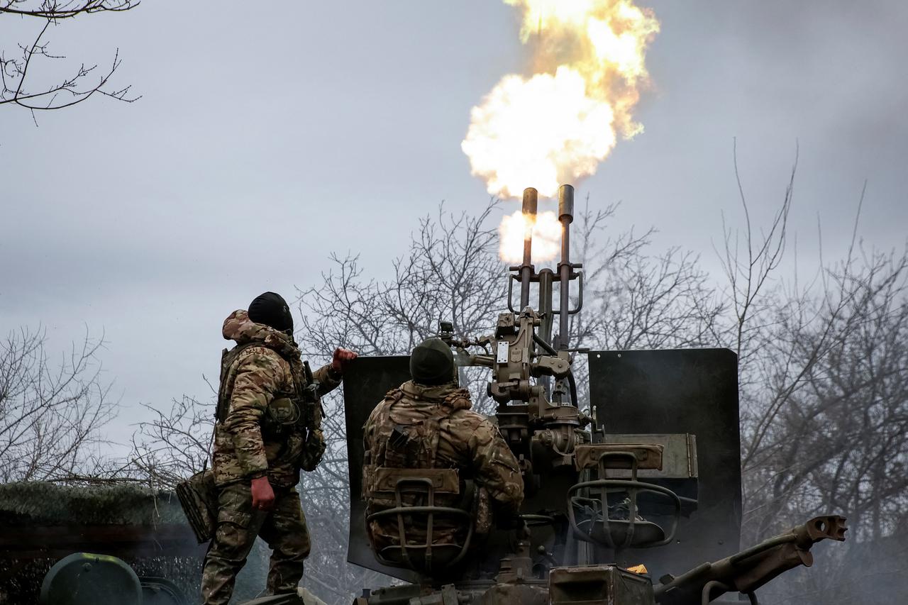Ukrainian servicemen from air defence unit fire an anti aircraft cannon at a frontline near the town of Bakhmut