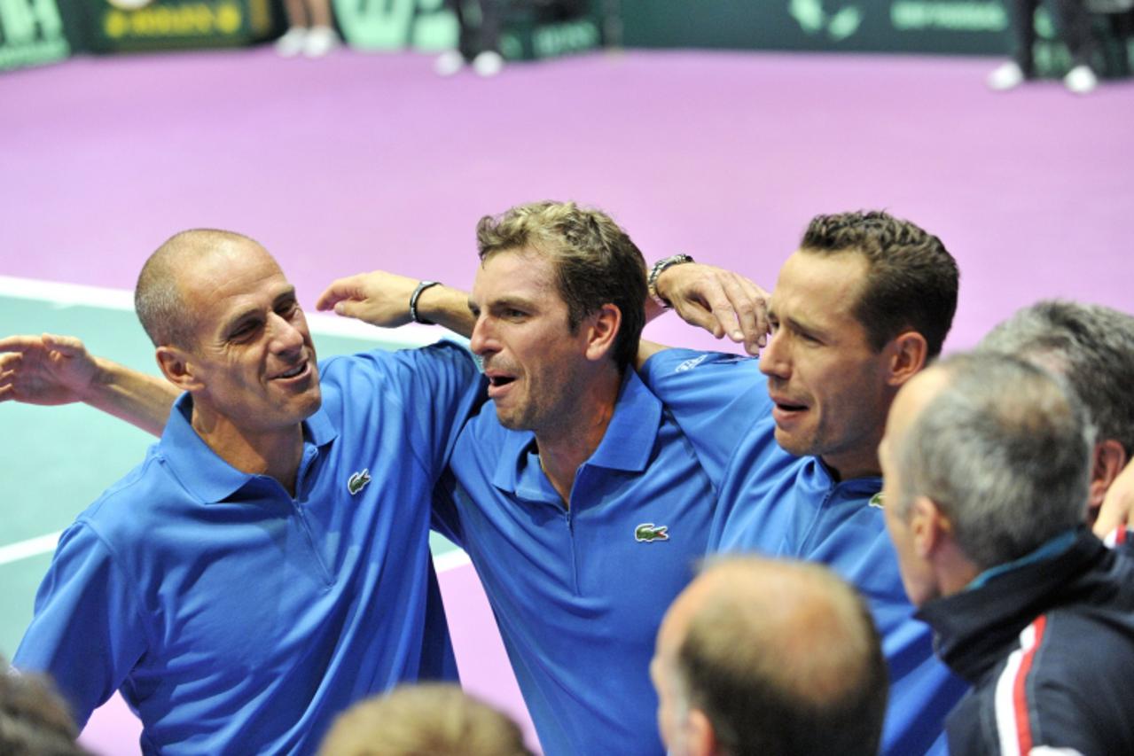 'French double pairing Michael Llodra (L) and Julien Benneteau (C) celebrate with their coach Guy Forget (L) after their victory against Fernando Verdasco and Feliciano Lopez during their Davis Cup te