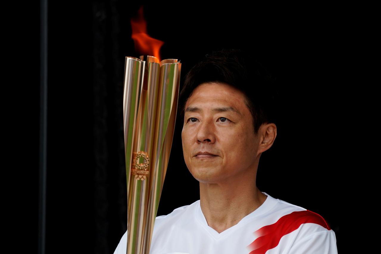 Tokyo's first torchbearer Matsuoka holds the torch during a lighting ceremony in Tokyo