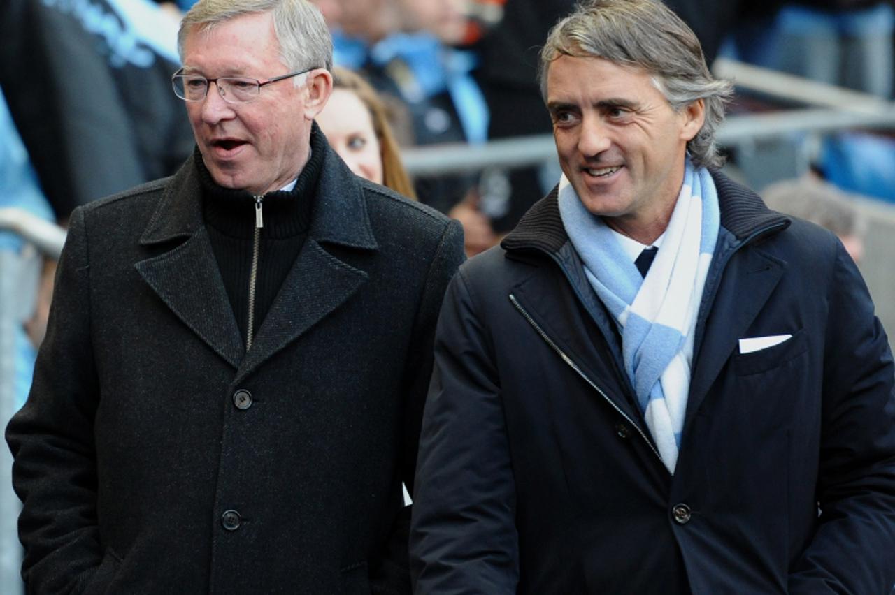 \'Manchester United manager Alex Ferguson (L) and Manchester City\'s Italian manager Roberto Mancini speak before the start of their English Premier League football match at The Etihad stadium in Manc