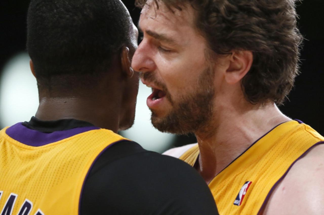 'Los Angeles Lakers Pau Gasol of Spain (R) celebrates with Dwight Howard during their NBA basketball game overtime win against the Houston Rockets in Los Angeles April 17, 2013.  REUTERS/Lucy Nicholso