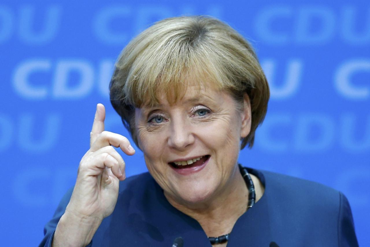 'German Chancellor and leader of the Christian Democratic Union ( CDU) Angela Merkel, gestures during a news conference after a CDU party board meeting in Berlin September 23, 2013, the day after the 