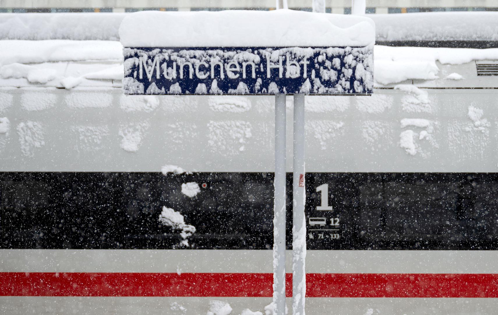 02 December 2023, Bavaria, Munich: A snow-covered sign at the main station. Snow and ice have caused chaos on the roads and on the railroads in southern Bavaria. Photo: Lukas Barth/dpa Photo: Lukas Barth/DPA